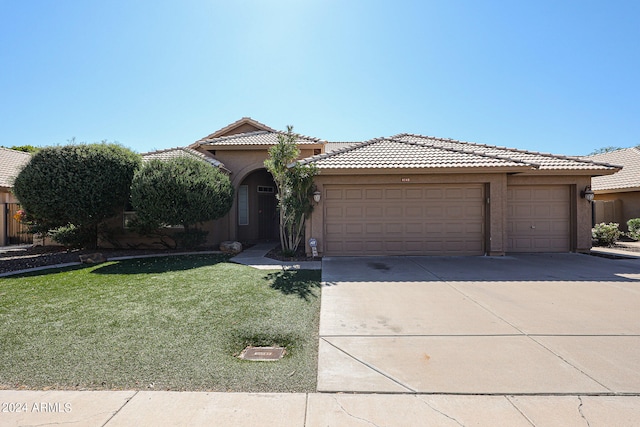 view of front of house with a garage and a front yard