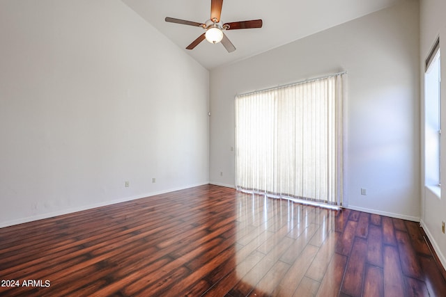 empty room with dark hardwood / wood-style floors, ceiling fan, and high vaulted ceiling