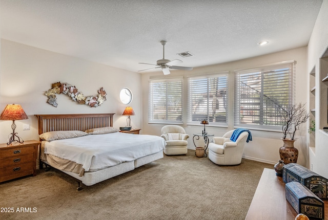 carpeted bedroom with multiple windows, a textured ceiling, and ceiling fan