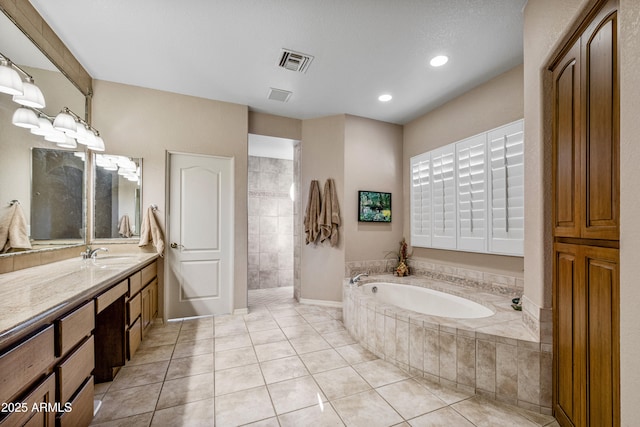 bathroom featuring tile patterned floors, vanity, and separate shower and tub