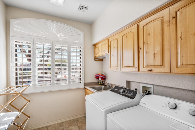 laundry room with washer and clothes dryer, cabinets, and sink