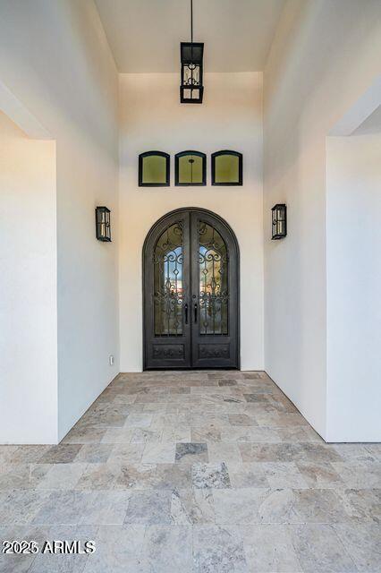 doorway to property with stucco siding and french doors