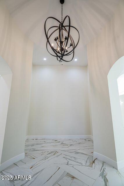 details with a chandelier and baseboards