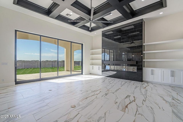 unfurnished living room featuring baseboards, coffered ceiling, a towering ceiling, ceiling fan, and beam ceiling