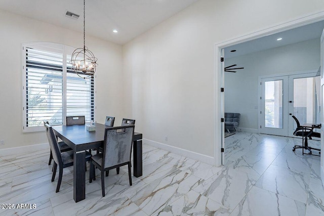 dining space featuring marble finish floor, baseboards, visible vents, and a notable chandelier