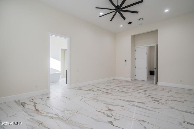 empty room featuring recessed lighting, marble finish floor, visible vents, and baseboards