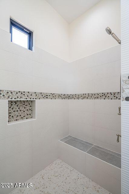 bathroom with a tile shower