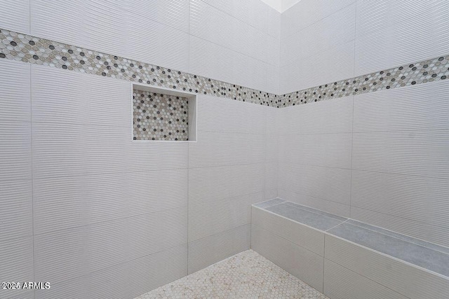 full bathroom featuring tiled shower