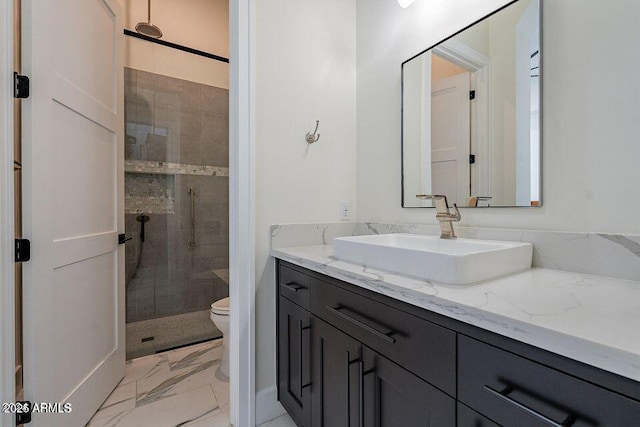 bathroom featuring marble finish floor, a shower stall, toilet, and vanity