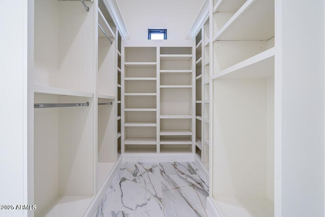 spacious closet featuring marble finish floor