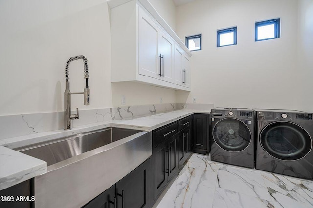 washroom featuring cabinet space, marble finish floor, a sink, and independent washer and dryer