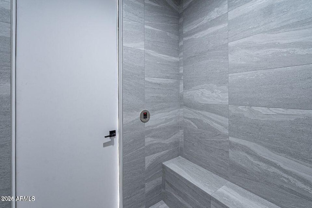 bathroom with tiled shower