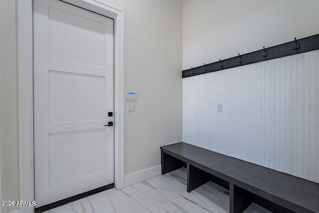 mudroom featuring marble finish floor and baseboards