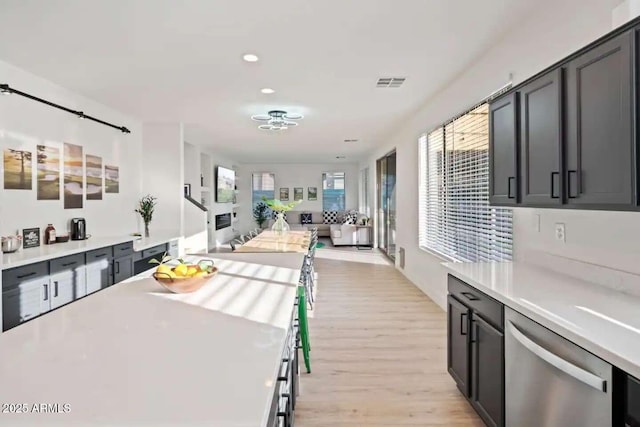29228 N 48th St, Cave Creek, AZ 85331 - kitchen with light wood-style floors, light countertops, dishwasher, open floor plan, and visible vents
