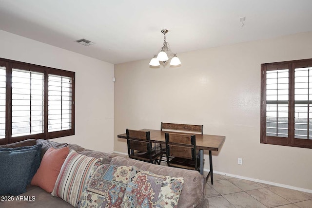 7712 S 37th Way, Phoenix, AZ 85042 - tiled living room with plenty of natural light, a chandelier, and baseboards