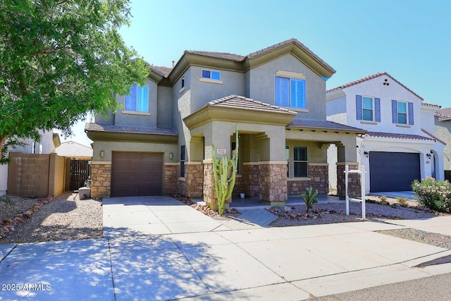 7712 S 37th Way, Phoenix, AZ 85042 - view of front of house with an attached garage, stucco siding, concrete driveway, and stone siding