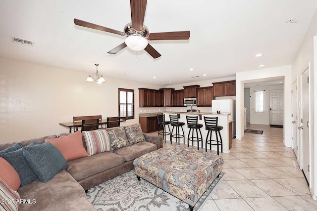 7712 S 37th Way, Phoenix, AZ 85042 - living area featuring ceiling fan, a chandelier, recessed lighting, and light tile patterned floors
