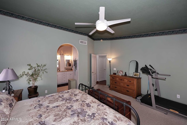 bedroom with carpet flooring, ceiling fan, and ensuite bathroom