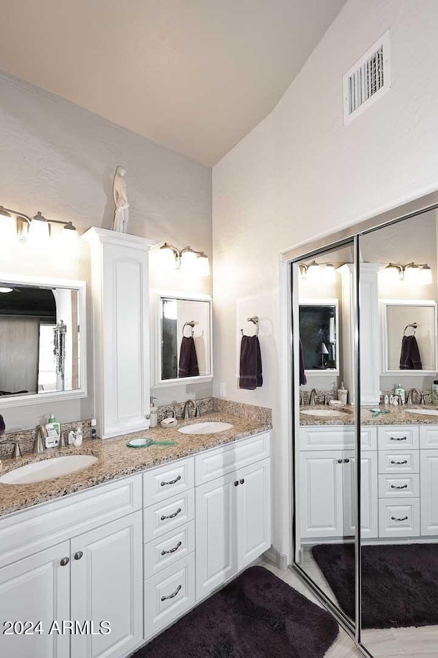 bathroom with vanity and vaulted ceiling