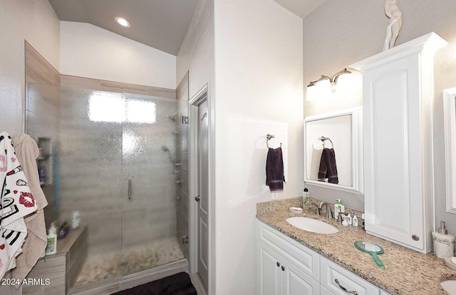 bathroom with vanity, an enclosed shower, and vaulted ceiling