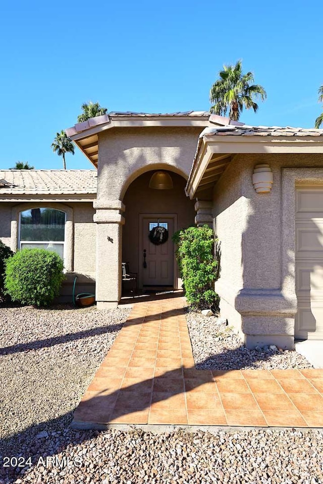 doorway to property with a garage