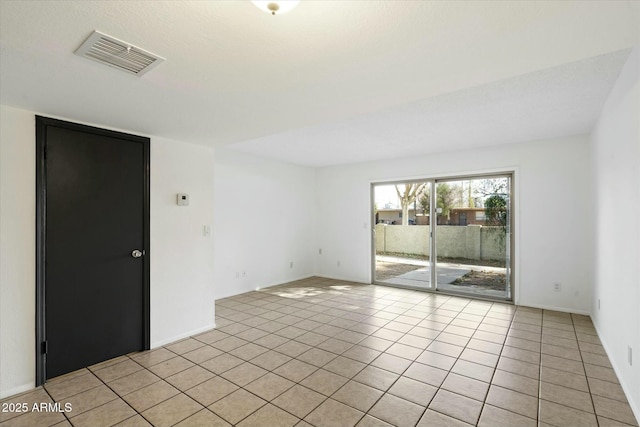 empty room with visible vents and light tile patterned floors