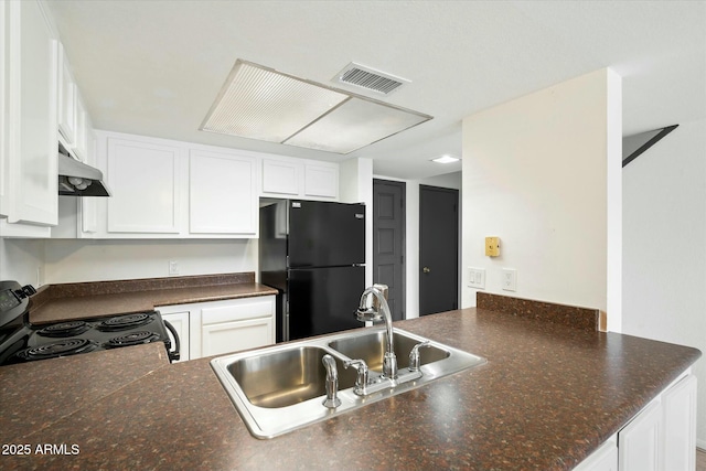 kitchen with visible vents, dark countertops, under cabinet range hood, black appliances, and a sink