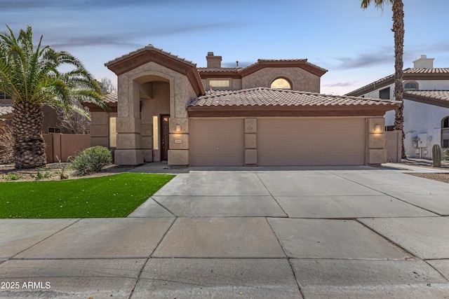 2461 E Stephens Pl, Chandler, AZ 85225 - mediterranean / spanish home featuring an attached garage, driveway, a tile roof, and stucco siding