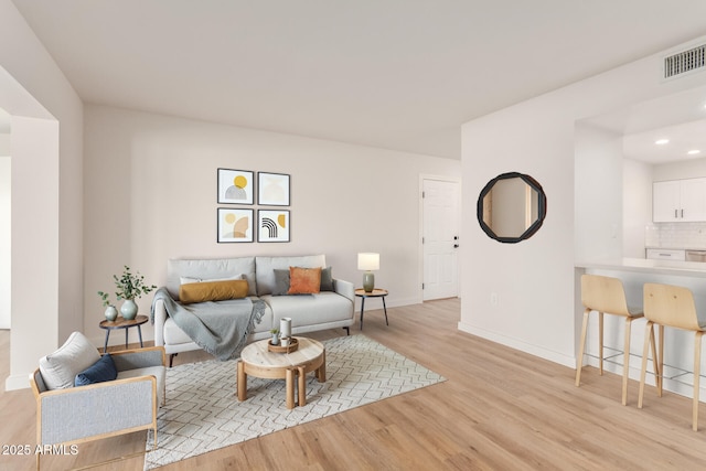 10750 W Abbott Ave, Sun City, AZ 85351 - living area featuring recessed lighting, baseboards, visible vents, and light wood finished floors