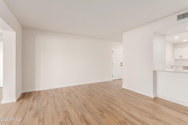 10750 W Abbott Ave, Sun City, AZ 85351 - unfurnished living room with baseboards, recessed lighting, visible vents, and light wood-style floors