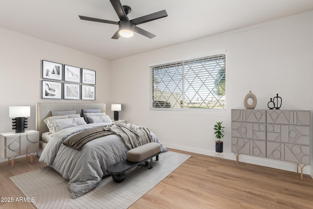 10750 W Abbott Ave, Sun City, AZ 85351 - bedroom with ceiling fan, wood finished floors, and baseboards
