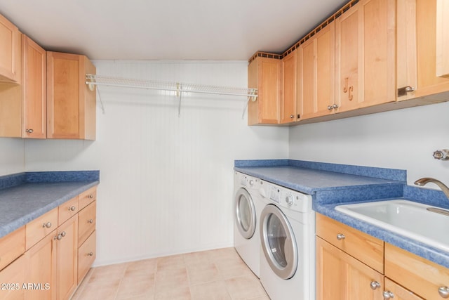 10750 W Abbott Ave, Sun City, AZ 85351 - clothes washing area with washing machine and dryer, a sink, cabinet space, and baseboards