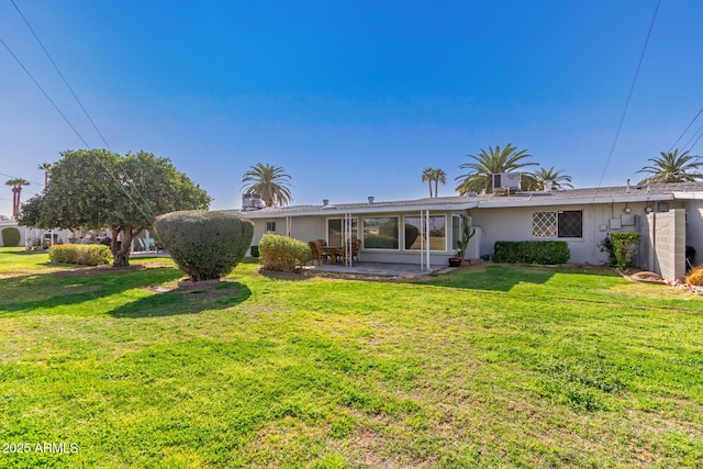 10750 W Abbott Ave, Sun City, AZ 85351 - rear view of property featuring a patio, a lawn, and a sunroom