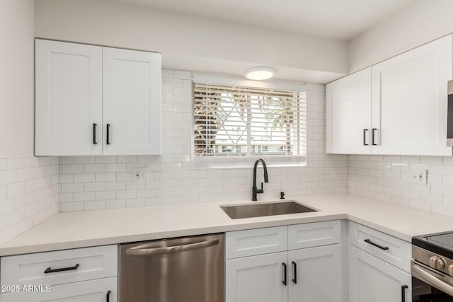 10750 W Abbott Ave, Sun City, AZ 85351 - kitchen with stainless steel appliances, white cabinets, a sink, and decorative backsplash