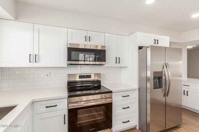 10750 W Abbott Ave, Sun City, AZ 85351 - kitchen featuring appliances with stainless steel finishes, light countertops, white cabinets, and tasteful backsplash