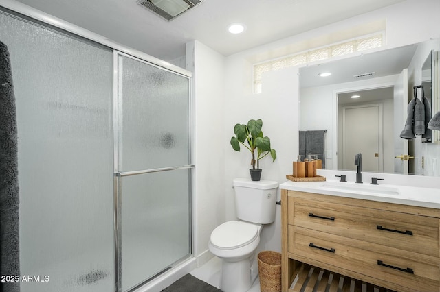 bathroom featuring vanity, toilet, and walk in shower