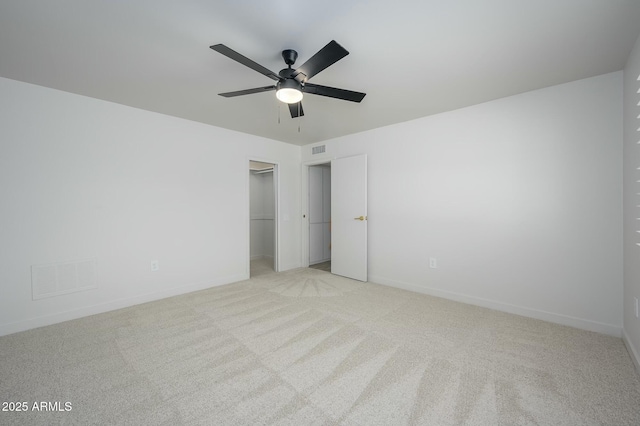 unfurnished bedroom with light carpet, ceiling fan, and a closet