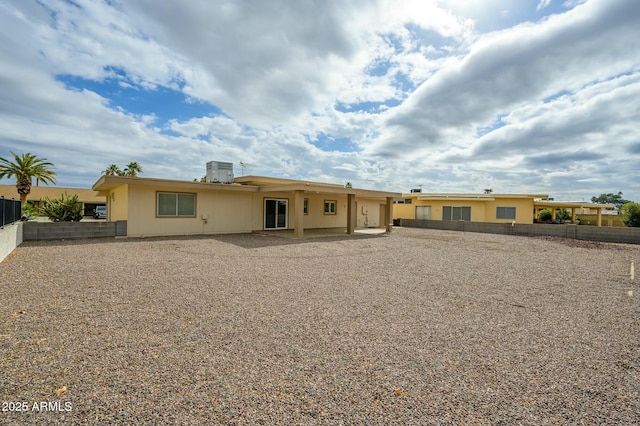 rear view of house with a patio and central AC unit