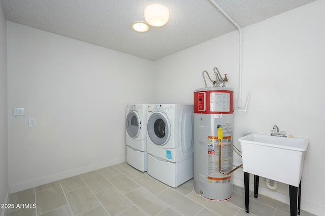 laundry room featuring water heater, separate washer and dryer, and a textured ceiling