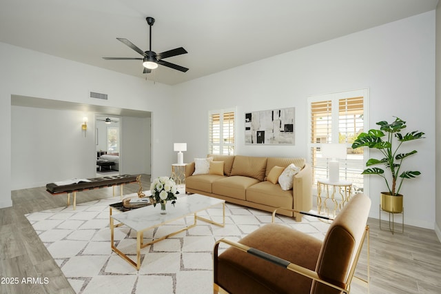 living room with ceiling fan and light hardwood / wood-style flooring