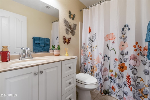 bathroom with curtained shower, vanity, toilet, and tile patterned floors