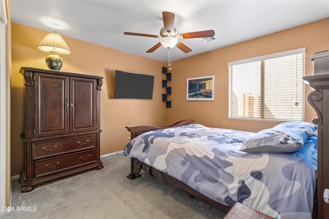 bedroom with ceiling fan and light colored carpet