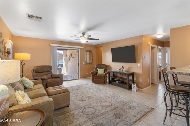 living room featuring ceiling fan and light tile patterned floors