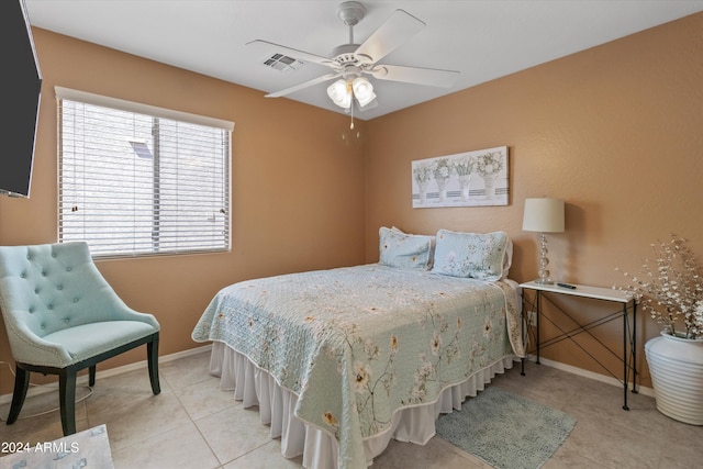 tiled bedroom featuring ceiling fan