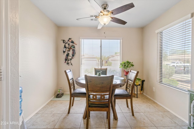 tiled dining area with a healthy amount of sunlight and ceiling fan