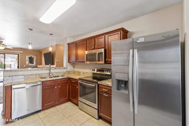 kitchen featuring sink, hanging light fixtures, stainless steel appliances, light tile patterned floors, and ceiling fan