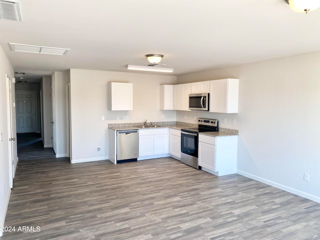 kitchen featuring sink, light wood-type flooring, white cabinetry, and stainless steel appliances