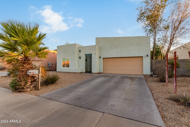 pueblo-style house featuring a garage