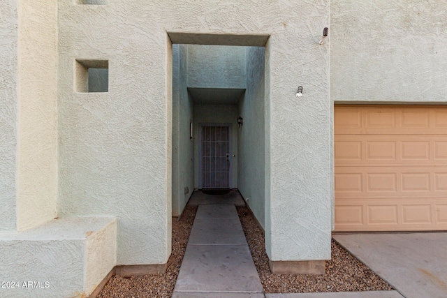 doorway to property featuring a garage