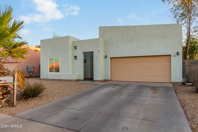 pueblo revival-style home with a garage